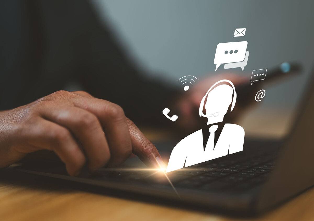 Laptop displaying icons for customer service, support, and digital communication channels such as email, phone, and chat.